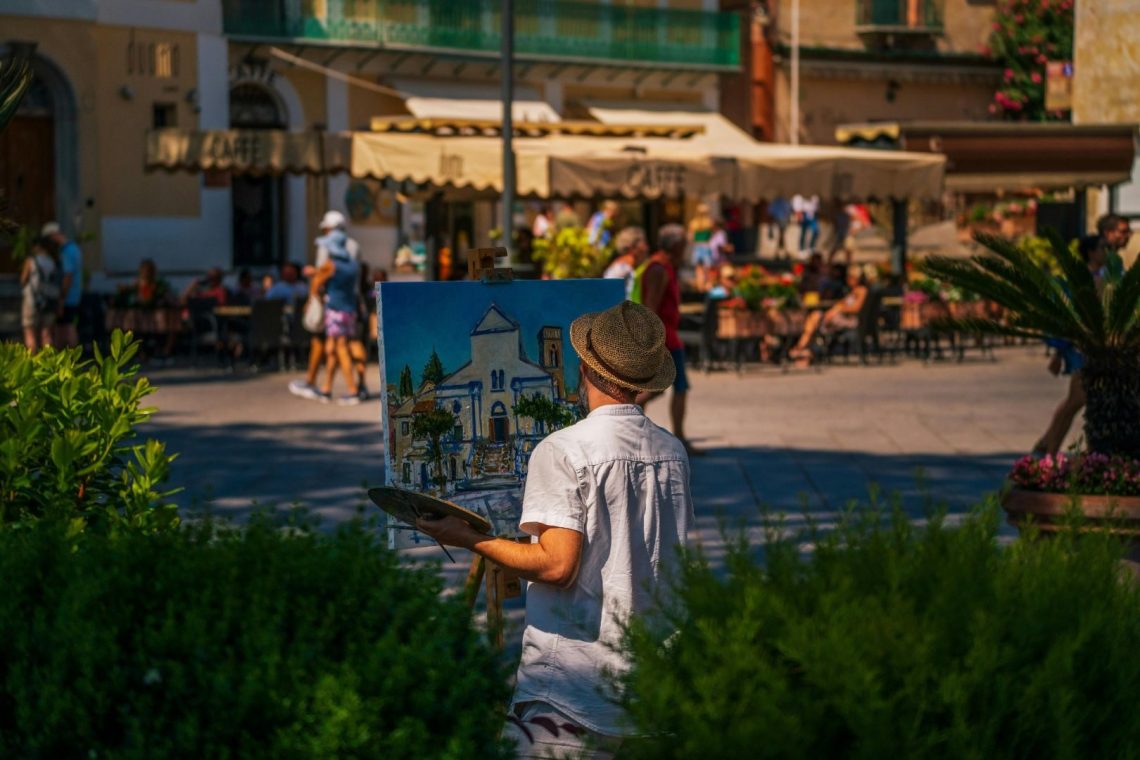katutaiteilija maalaa kirkkoa ravellossa
